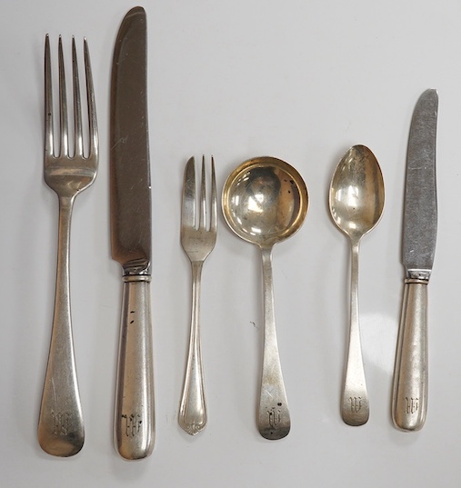 A part canteen of American sterling cutlery comprising thirty eight items, together with nine white metal handled dessert knives, nine table knives and six tea knives, all with engraved initial and a set of six silver pl